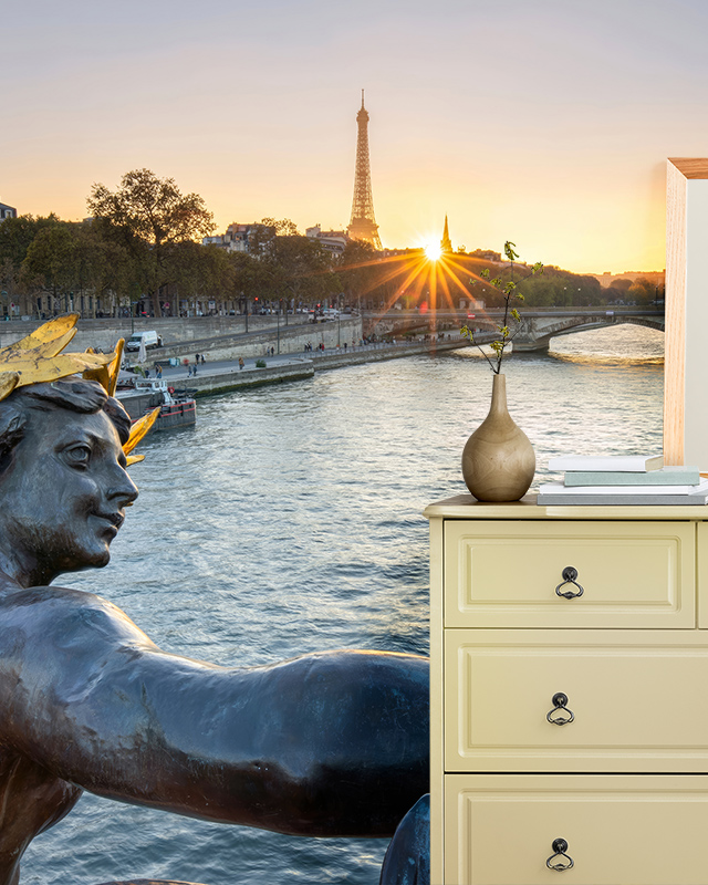 Sunset over the Eiffel Tower and Seine River mural in a bedroom, showcasing room-by-room bright wallpaper ideas.
