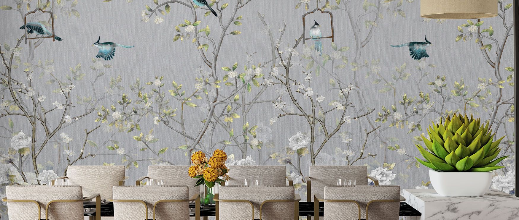 The Chisine Silver Birds Wallpaper presents a grey garden scene filled with elegant birds and lush foliage. Its calm imagery offers serenity, while metallic accents elevate interiors with sophistication. Perfect for restful bedrooms, refined dining areas,