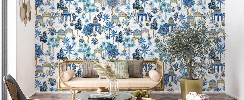 Room with a detailed botanical and architectural blue wallpaper, showcasing trees, plants, and gazebos. 