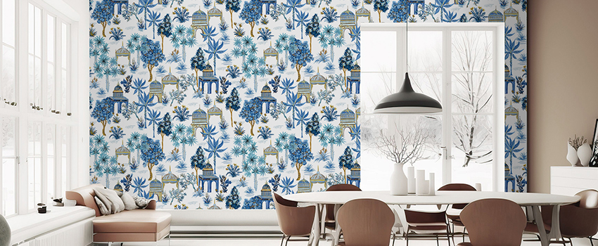 Dining room with intricate botanical and architectural blue wallpaper design, large windows in the background. 