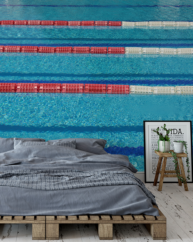 Swimming pool mural with blue wallpaper water and lane dividers brings a refreshing vibe to this bedroom, perfect for commercial spaces. 