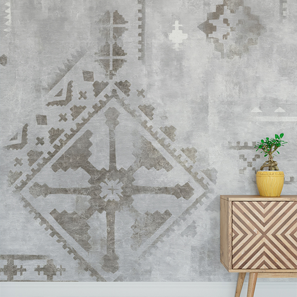 Intricate gray pattern with blue wallpaper behind a small wooden cabinet and plant 