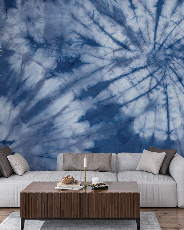 Blue wallpaper with spiral tie-dye design adds a bold, artistic touch to this living room, ideal for commercial spaces 